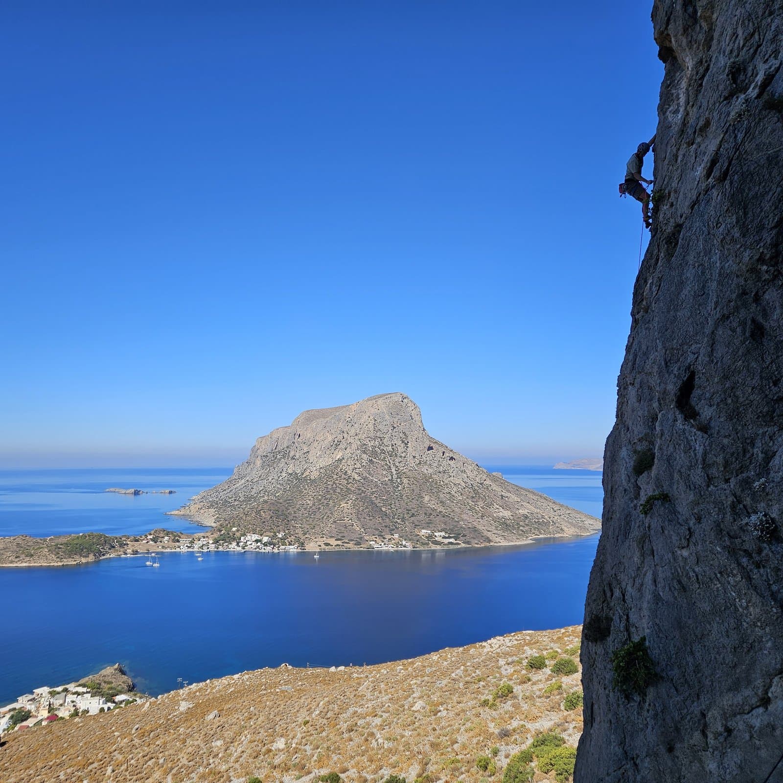 Climbing at Trois Ilots with Telendos island across the water